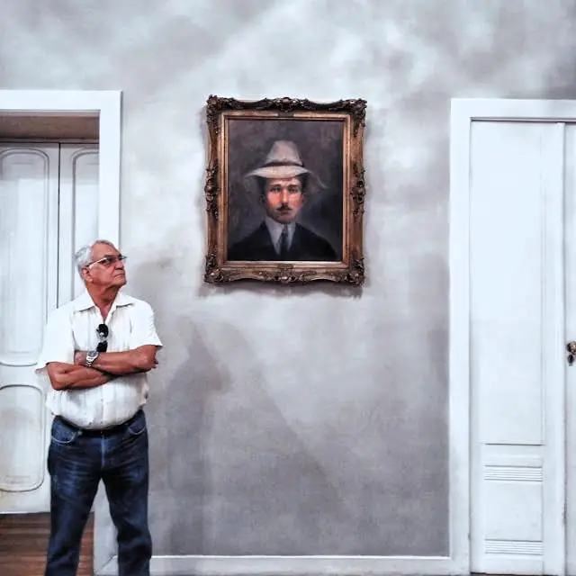 man looking at picture frame